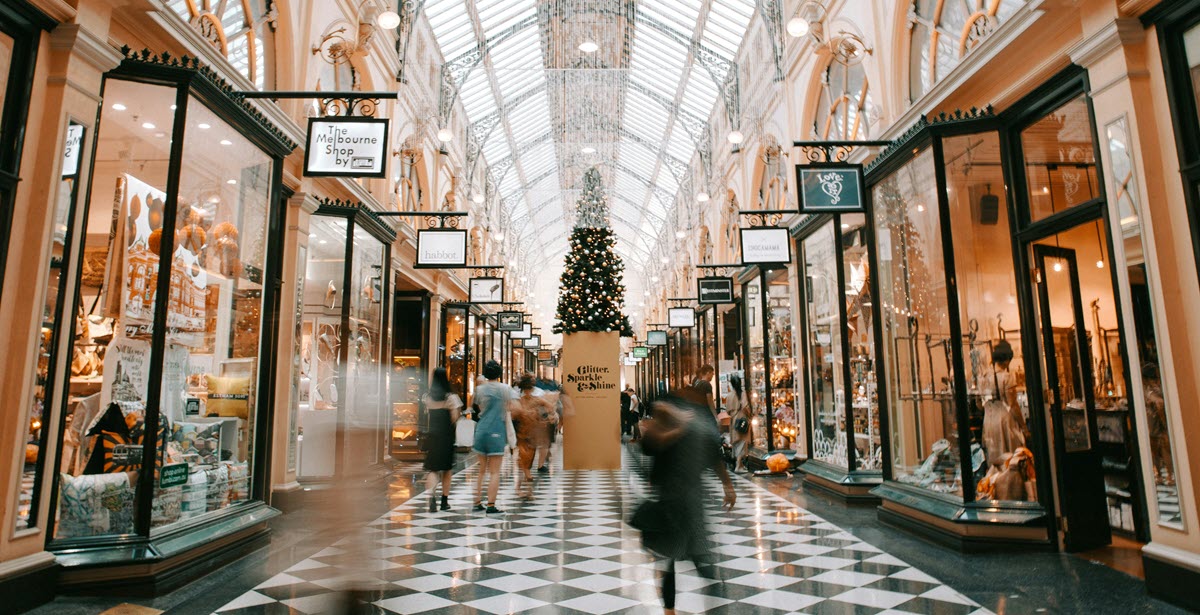 Image of shopping mall with shoppers moving about